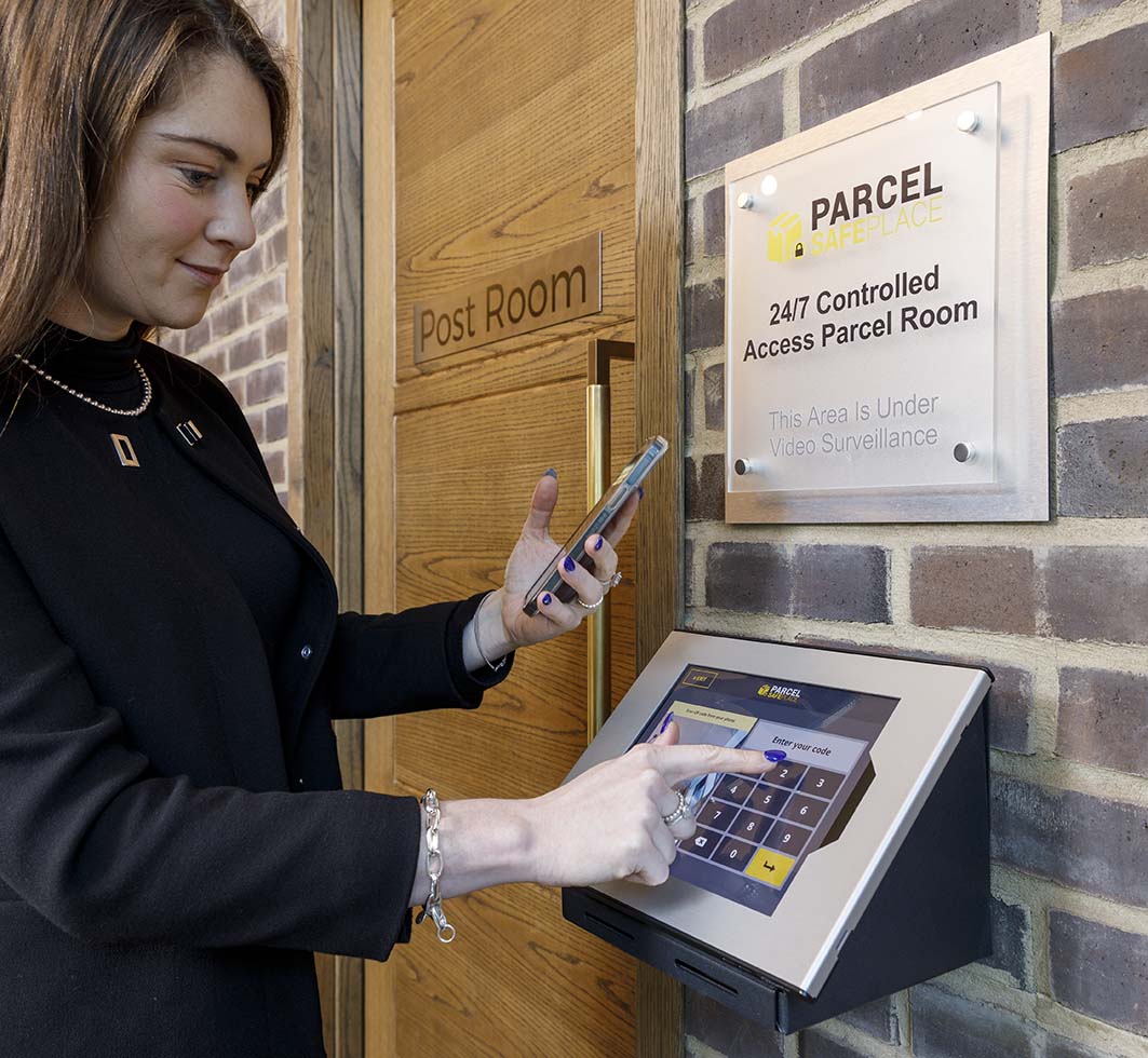 Resident entering access code on a touchscreen parcel management kiosk for a secure building parcel room.